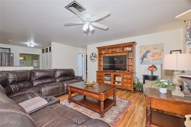 living room with ceiling fan and light hardwood / wood-style floors