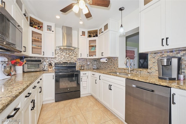 kitchen with decorative backsplash, wall chimney exhaust hood, sink, black appliances, and white cabinets