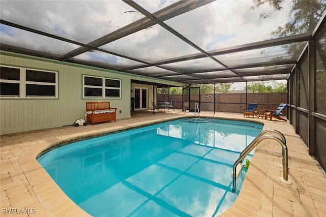 view of swimming pool with a patio area, a lanai, and french doors