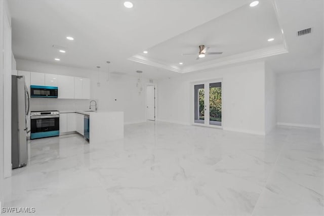 living room featuring a raised ceiling, ceiling fan, crown molding, and sink