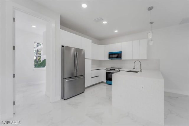 kitchen with white cabinets, sink, hanging light fixtures, and appliances with stainless steel finishes