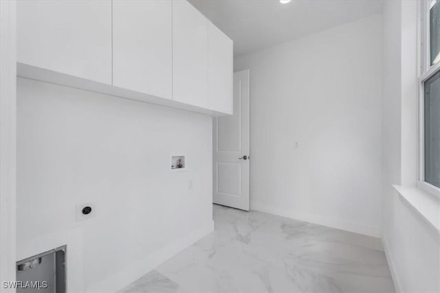 clothes washing area with washer hookup, hookup for an electric dryer, and cabinets