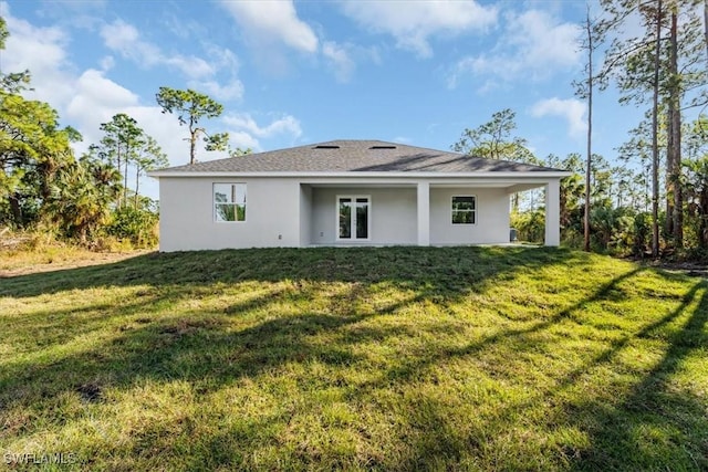 rear view of house with a yard