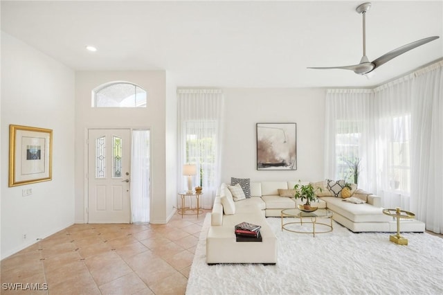 unfurnished living room with ceiling fan and light tile patterned floors