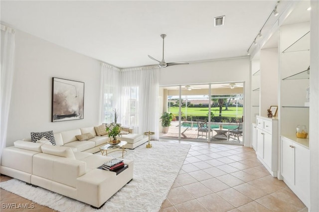 living room featuring light tile patterned floors and rail lighting