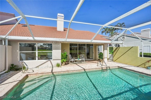 view of swimming pool with a lanai and a patio area