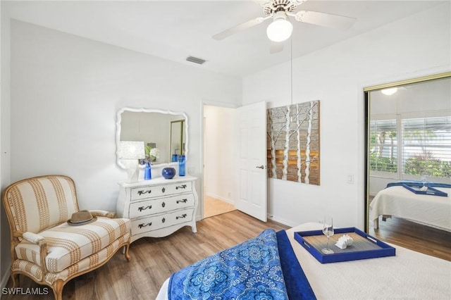 bedroom with ceiling fan and hardwood / wood-style flooring