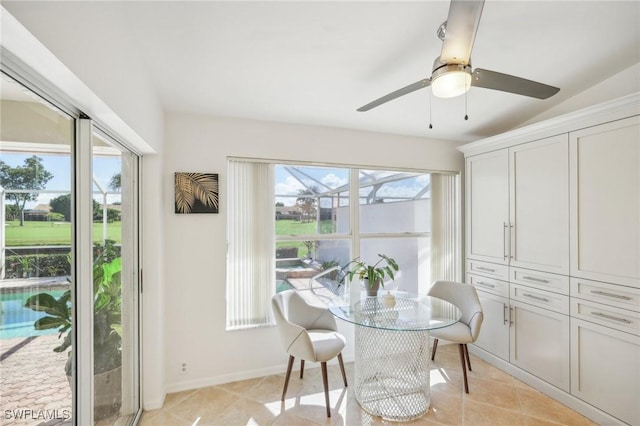 dining room with light tile patterned floors, ceiling fan, and lofted ceiling