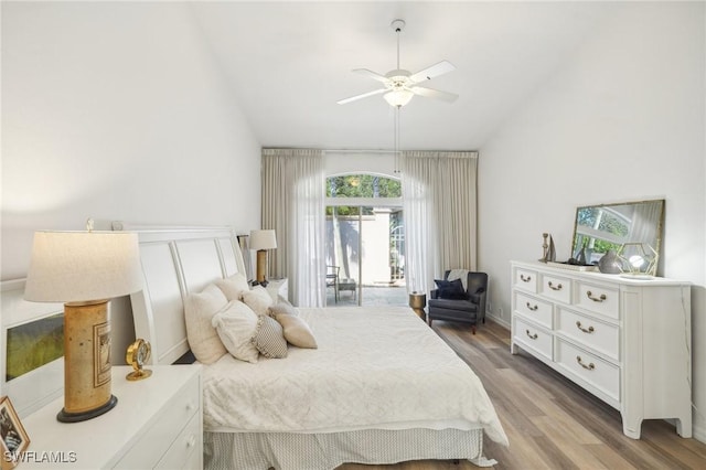 bedroom featuring access to outside, hardwood / wood-style flooring, ceiling fan, and lofted ceiling