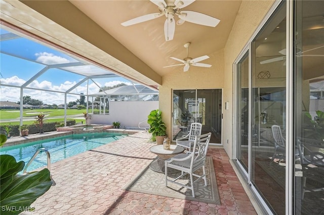 view of pool featuring a lanai, a patio area, and ceiling fan