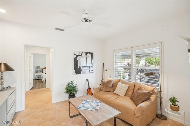 living room featuring ceiling fan and light tile patterned floors