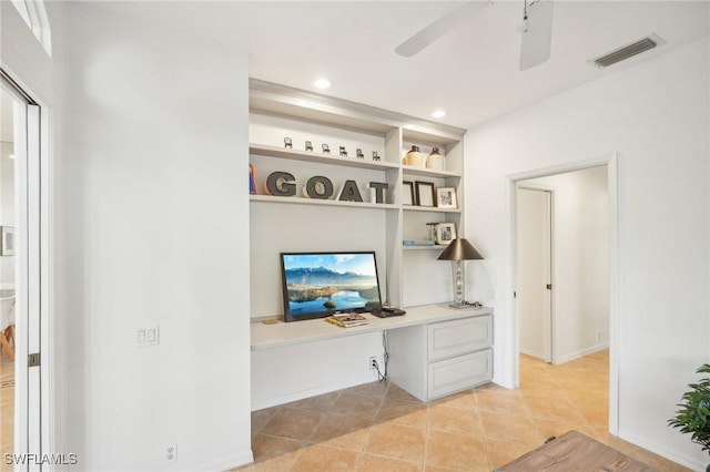 interior space featuring ceiling fan and built in desk