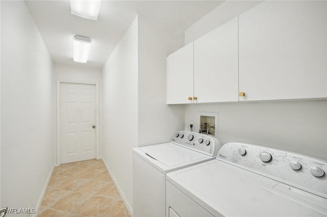 laundry room featuring cabinets, separate washer and dryer, and light tile patterned floors