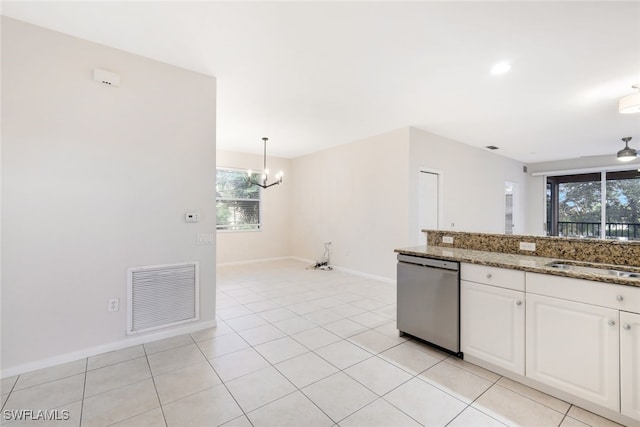 kitchen featuring white cabinets, dark stone counters, sink, pendant lighting, and dishwasher