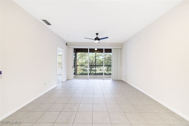 tiled empty room with ceiling fan