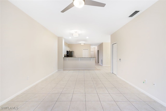 unfurnished living room with ceiling fan and light tile patterned flooring