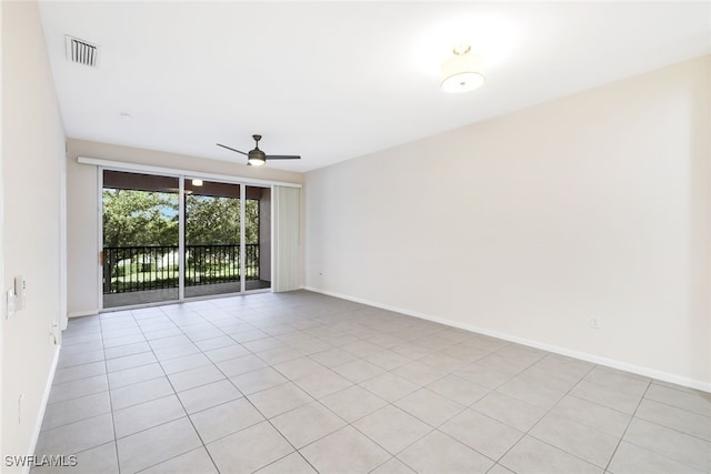 tiled spare room featuring ceiling fan