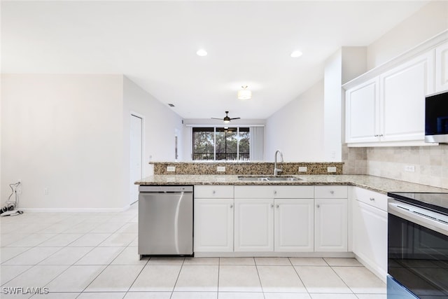 kitchen featuring kitchen peninsula, stainless steel appliances, ceiling fan, sink, and white cabinetry