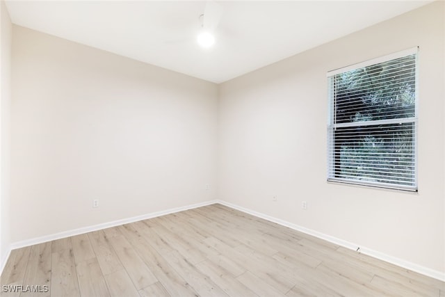 empty room with plenty of natural light and light hardwood / wood-style floors