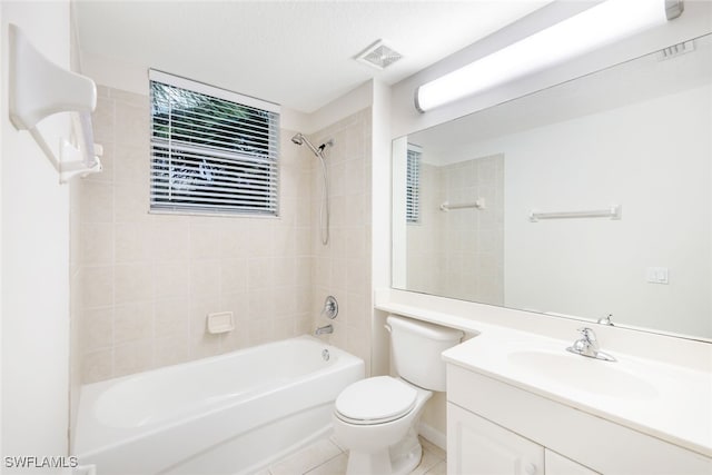 full bathroom featuring tile patterned flooring, vanity, toilet, and tiled shower / bath combo