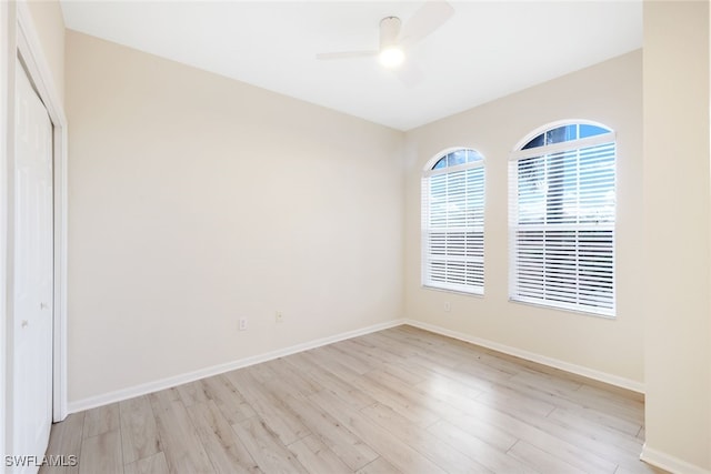 spare room featuring ceiling fan and light hardwood / wood-style flooring