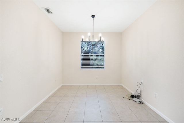 unfurnished dining area with light tile patterned floors and an inviting chandelier