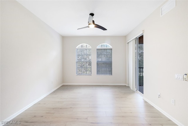 empty room with ceiling fan and light hardwood / wood-style flooring