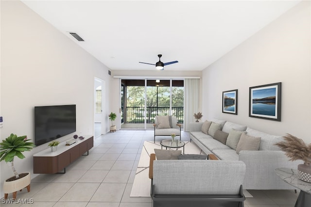 tiled living room with ceiling fan