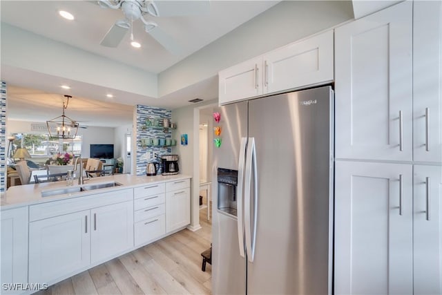 kitchen featuring white cabinetry, stainless steel fridge with ice dispenser, light hardwood / wood-style flooring, and sink