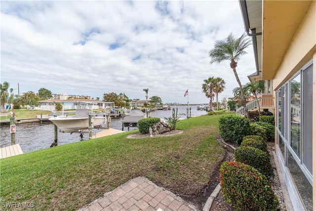 view of yard featuring a water view and a dock