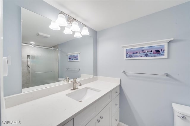 bathroom featuring vanity, toilet, and walk in shower