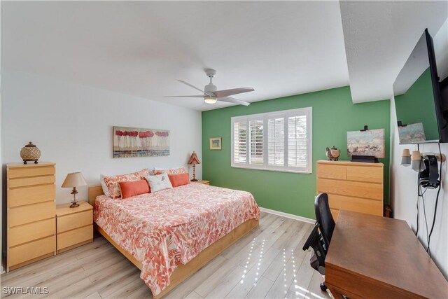 bedroom with ceiling fan and light hardwood / wood-style flooring