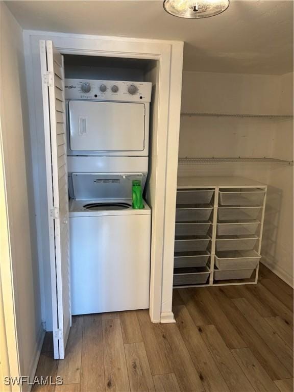 washroom featuring stacked washer and clothes dryer and hardwood / wood-style floors