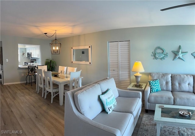 living room featuring hardwood / wood-style flooring and a chandelier