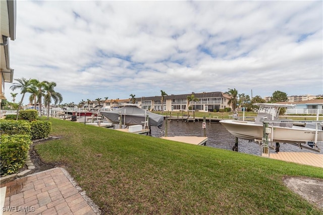 dock area with a water view and a lawn