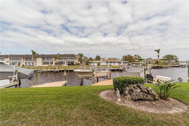 dock area with a water view and a yard