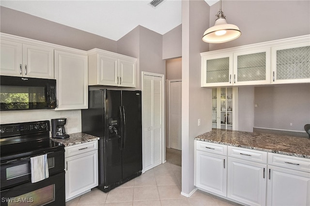 kitchen featuring white cabinetry, light tile patterned floors, and black appliances