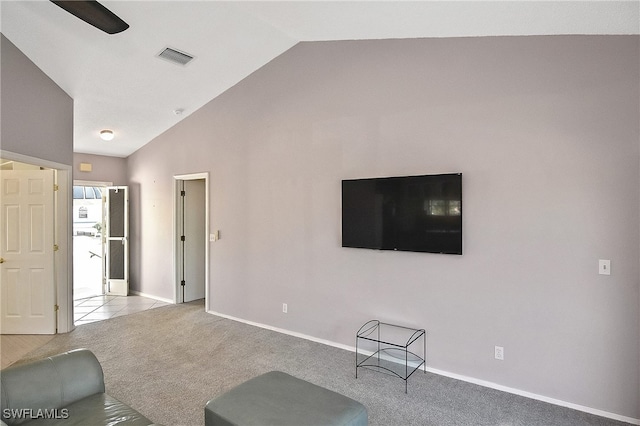 carpeted living room with lofted ceiling