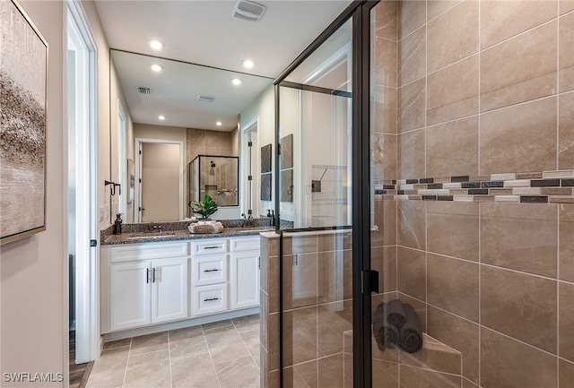 bathroom featuring tile patterned floors, vanity, and walk in shower