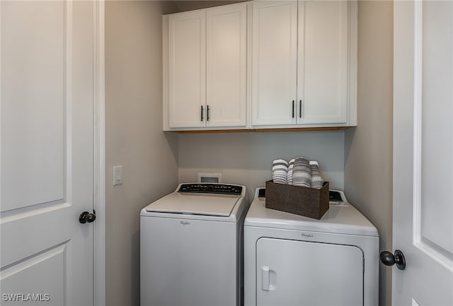 laundry area with cabinets and washing machine and clothes dryer