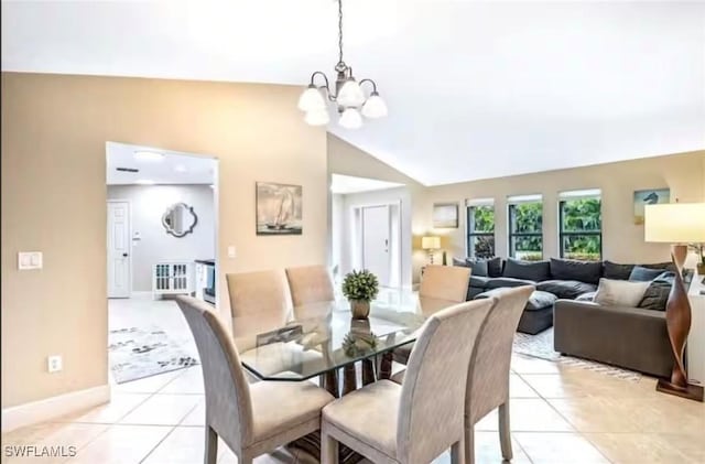 tiled dining space with vaulted ceiling and an inviting chandelier