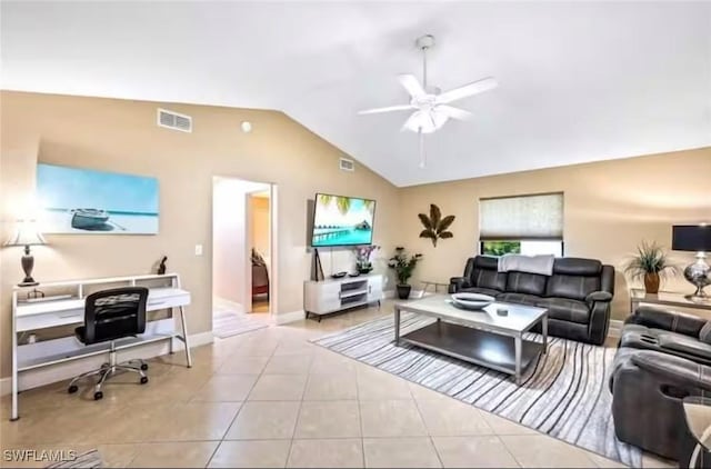 living room featuring ceiling fan, light tile patterned floors, and lofted ceiling