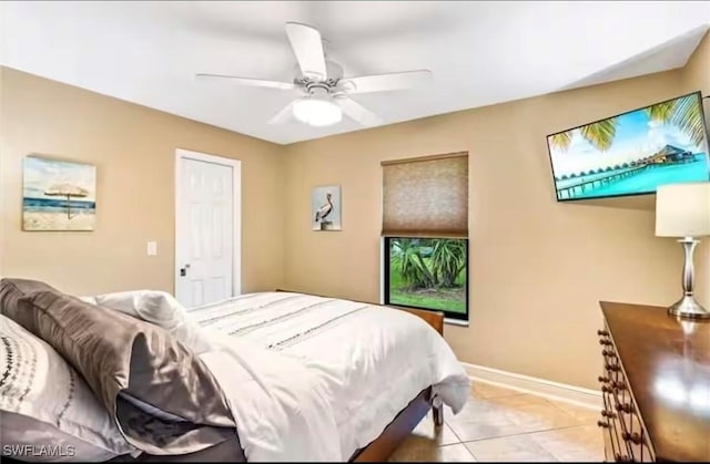 tiled bedroom featuring ceiling fan