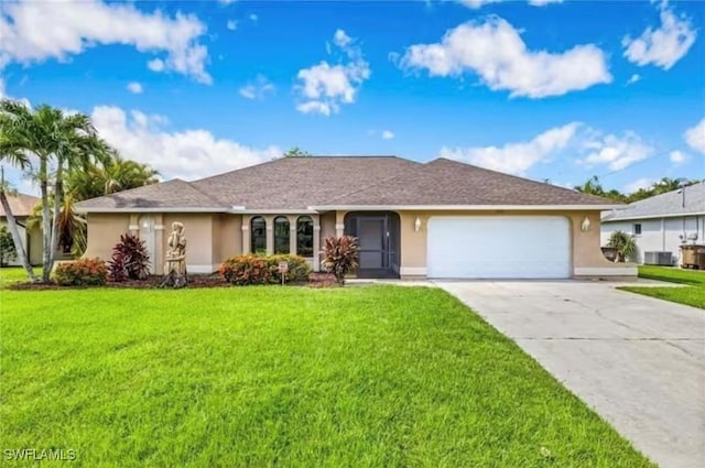 ranch-style house featuring a garage, a front lawn, and central AC unit