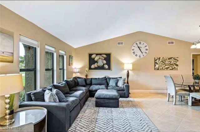 tiled living room featuring lofted ceiling and a notable chandelier