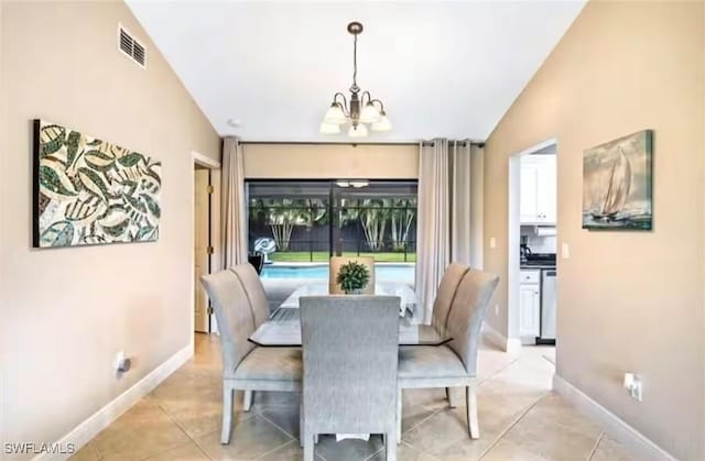 tiled dining space with vaulted ceiling and a notable chandelier