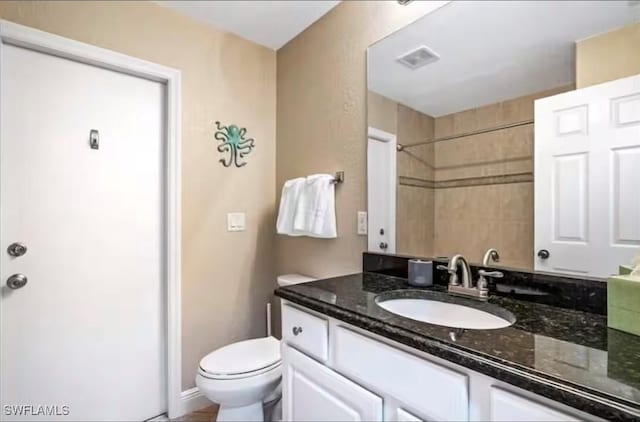 bathroom with toilet and vanity