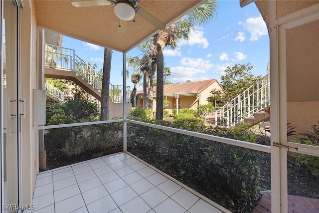 balcony featuring stairway and a ceiling fan