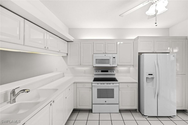 kitchen featuring light countertops, white appliances, white cabinets, and ceiling fan