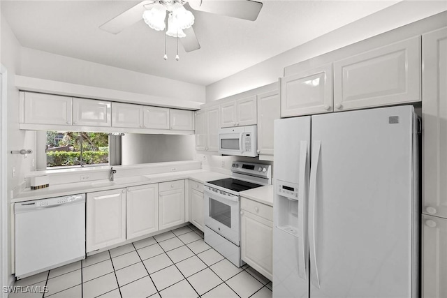 kitchen featuring light tile patterned floors, light countertops, white cabinetry, ceiling fan, and white appliances